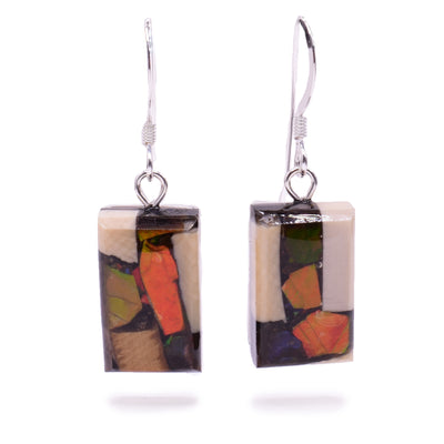 These dangling ammolite and mammoth ivory earrings have rectangle box earrings. The hangs are made by setting pieces of fossilized ivory and ammolite into a rectangle shape.