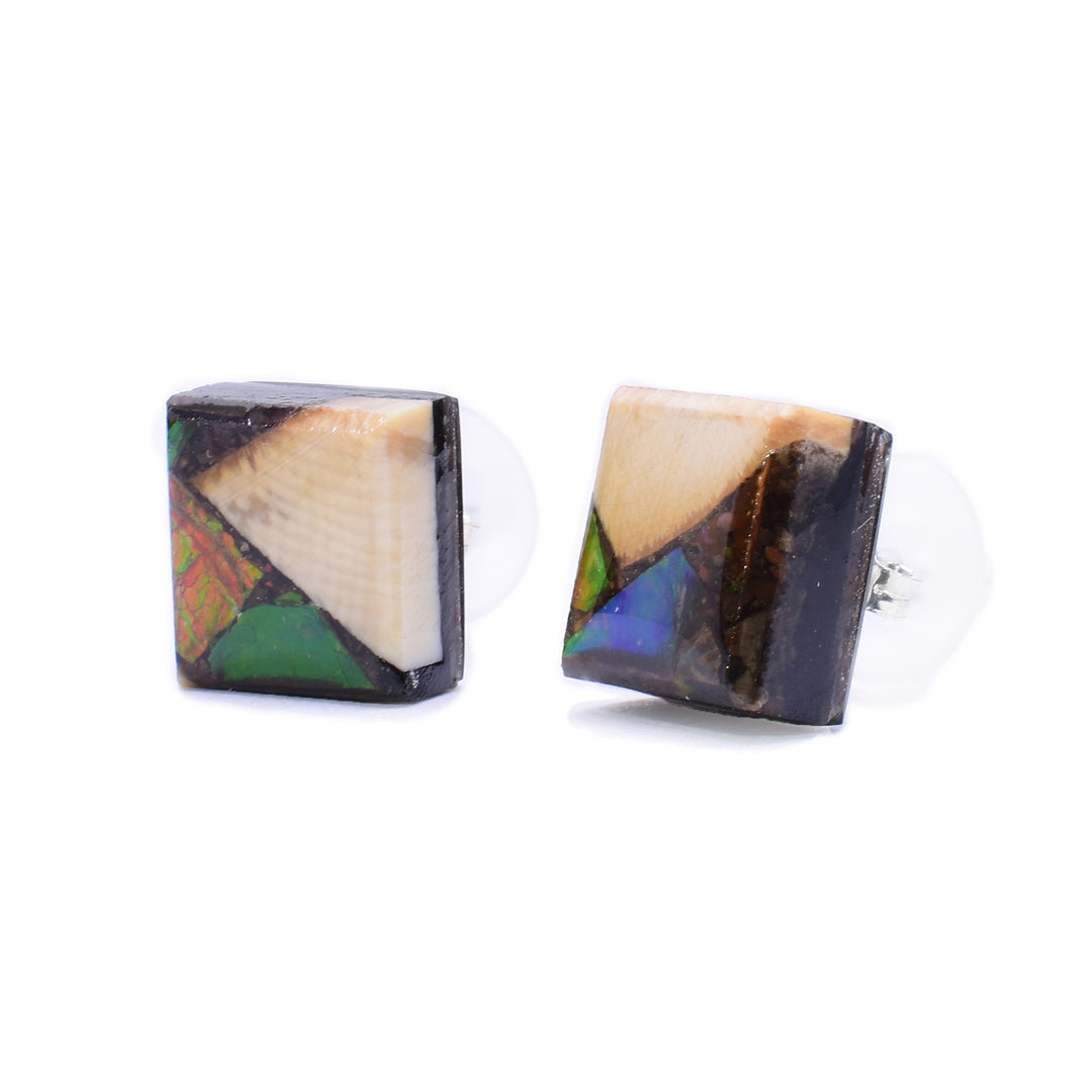 These ammolite and mammoth ivory earrings are chunky, square studs. The earrings are a combination of pieces of ivory and ammolite.