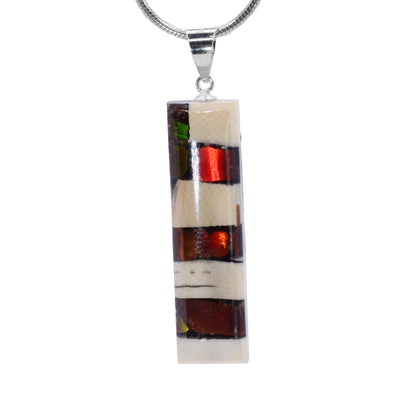 This ammolite gemstone and mammoth ivory pendant has a thin rectangle shaped and a sterling silver jump ring. There is a striped pattern on the piece achieved by layering the two materials on top of each other.