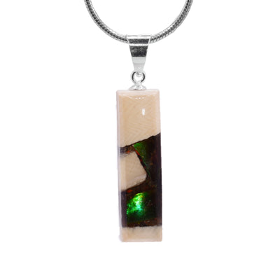 This ammolite gemstone and mammoth ivory pendant has a thin rectangle shaped and a sterling silver jump ring.