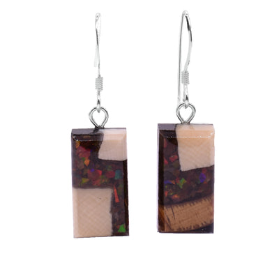 These dangling ivory earrings are made from ammolite gemstone and fossilized mammoth ivory. The hangs are rectangular and are made by setting pieces of ammolite and ivory into resin.