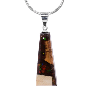 This ammolite pendant is made from fossilized mammoth ivory and ammolite gemstones. Chunks of ivory and ammolite are set in resin and make a short, tapered shape.