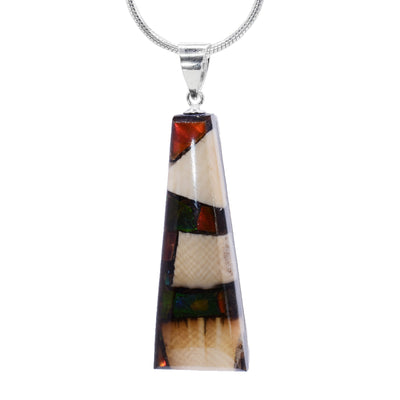 This Ivory pendant is made by setting chunks of fossilized mammoth ivory into resin. The pendant is short, triangular and tapered. It hangs from a simple bail.