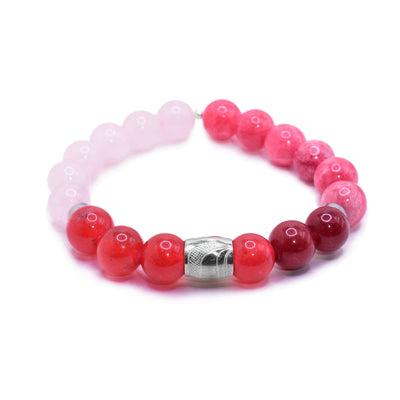 This bracelet with rose quartz has red quartz and rose quartz beads. The beads are small and sphere shaped. There is a sterling silver spirit bead in the center with the head of the Raven carved into it. There are two round and flat silver spacers.