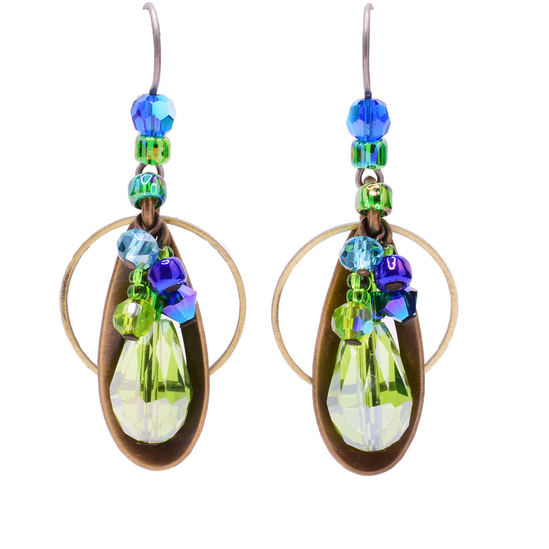 Dangle earrings made of Swarovski crystal, handworked brass, pressed glass, and B.C Studio art glass. Titanium ear hooks. By Honica.
