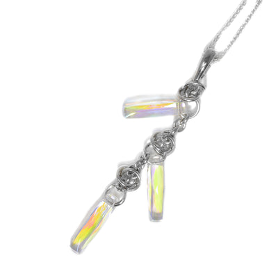 Lariat style pendant. Medium-sized and small sterling silver rings link together to create a chain. Three skinny aurora borealis Swarovski crystals hang off at the top, middle and bottom.