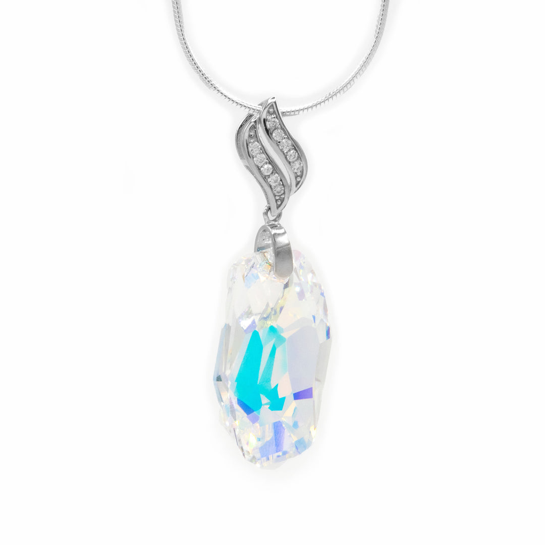 Aurora borealis meteor-shaped Swarovski crystal pendant with sterling silver, cubic-zirconia adorned bail. By artist Debra Nelson.