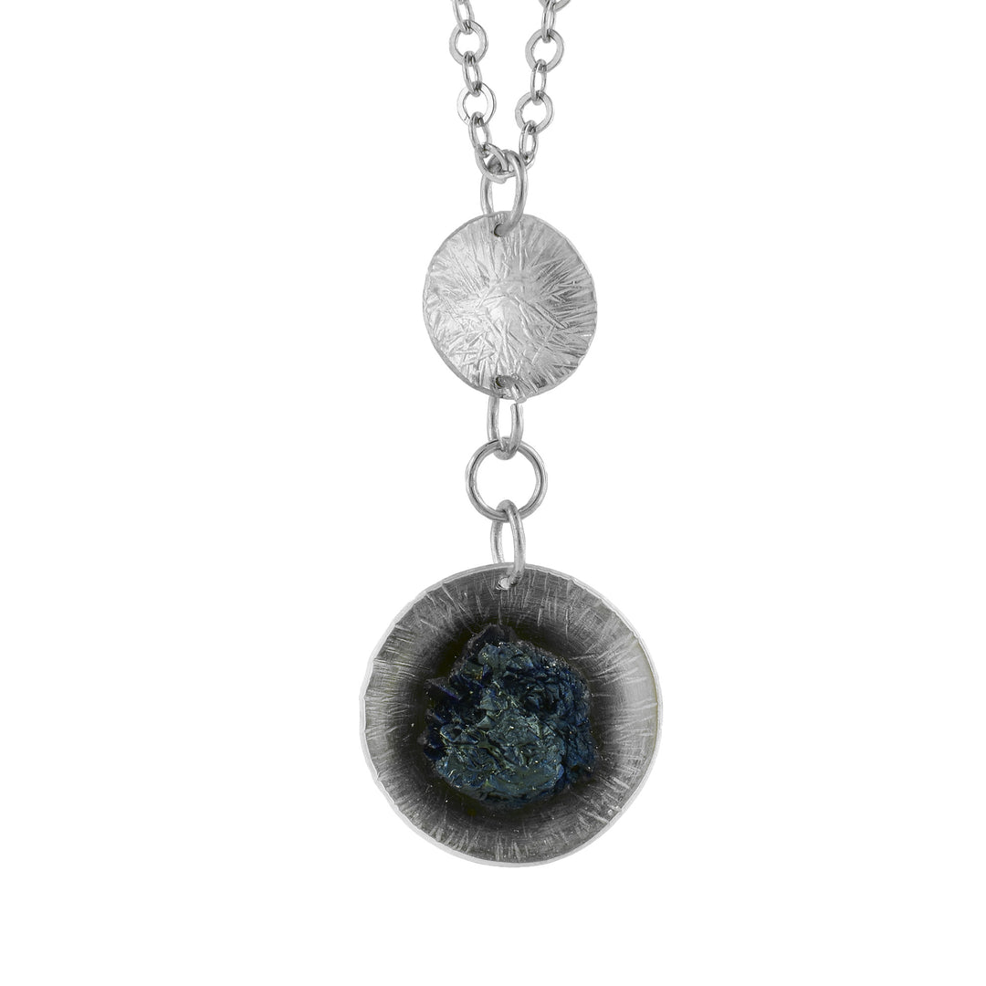 This Azurite mineral with deep blue hues is attached to circular 925 Silver to create this Pendant
