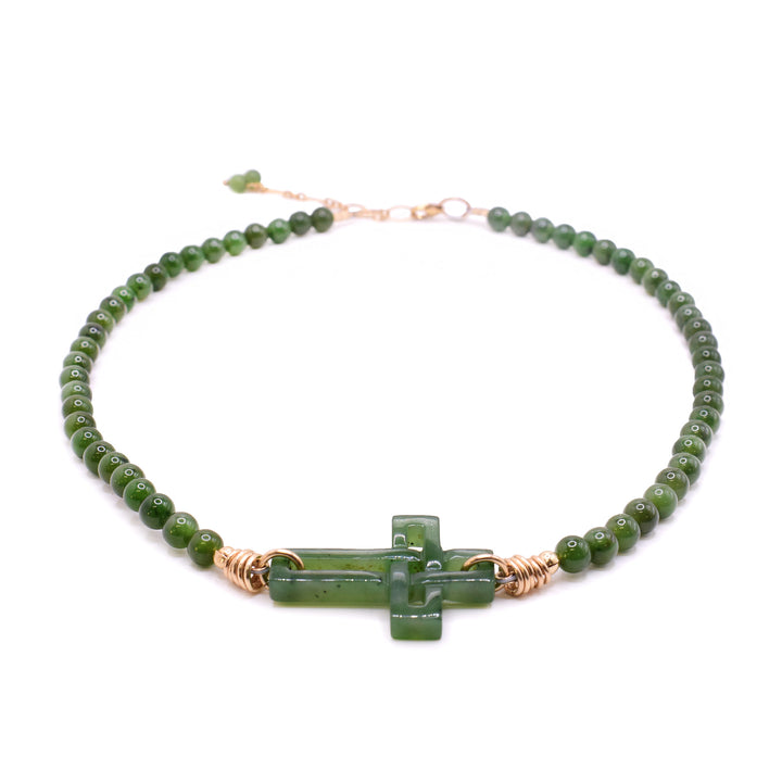 Handmade BC jade necklace with a carved sideways cross and polished jade beads, finished with gold fill wire and clasp. Made by our in-house artists.