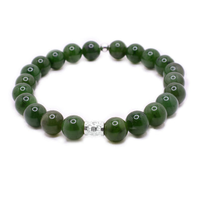 BC jade beaded bracelet with 0.3” jade beads, a small ornate sterling silver bead in front and a tiny round sterling silver bead in back.