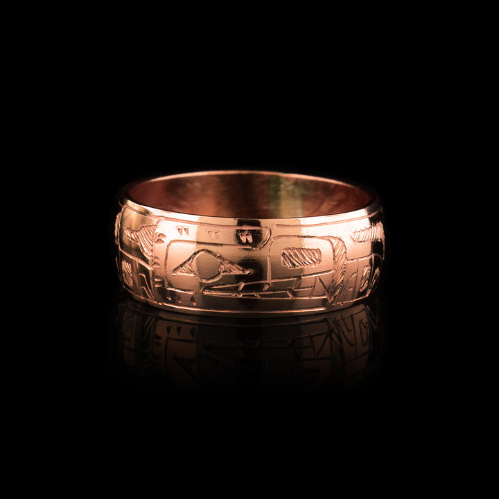Band ring made of copper with the indigenous legend of the bear carved on its surface. 