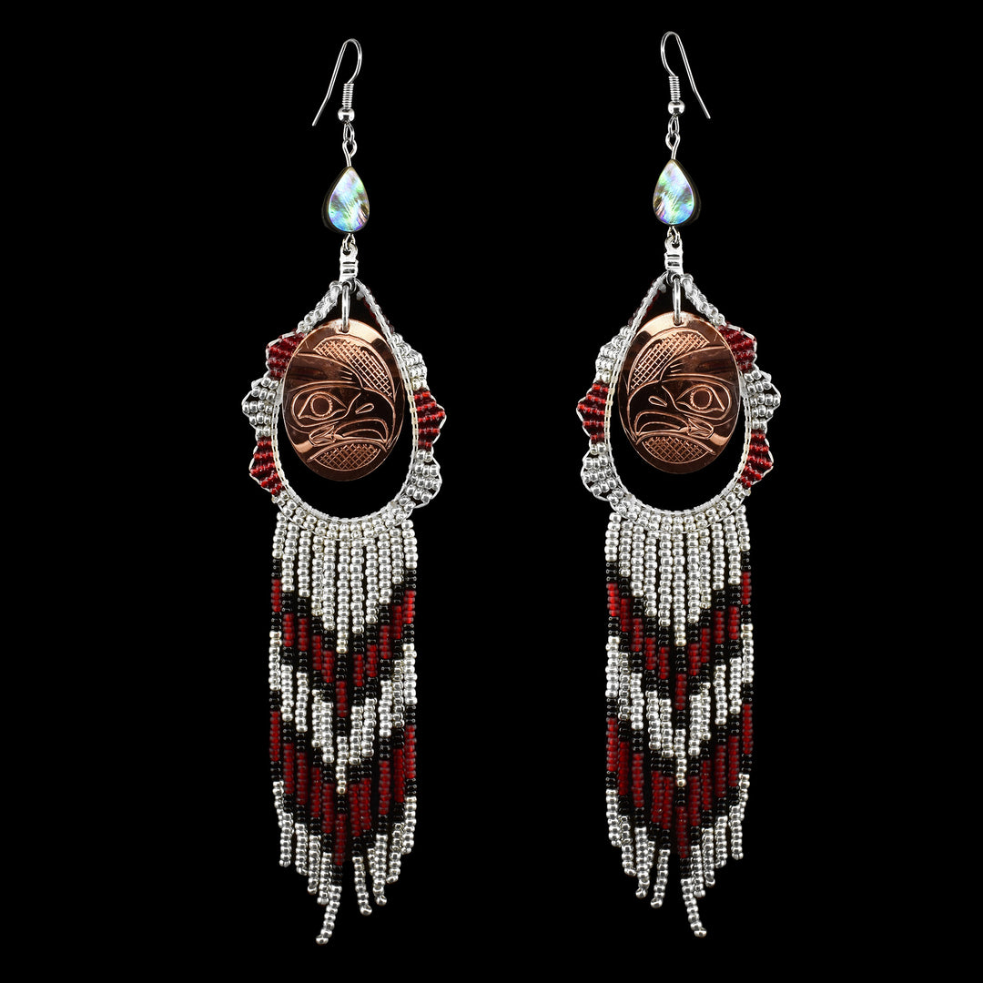 Handcrafted by Coast Salish artist Bambi Lancaster, these Beaded Eagle Dangling Earrings feature stunning copper with Eagle legend carved inside & teardrop abalone on top of the earrings attached to the hooks with detailed red, black, and white beading. Shop authentic art at Artina's.