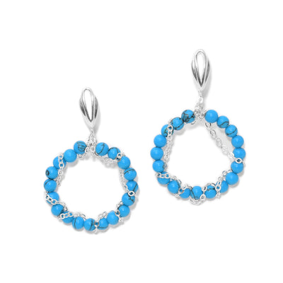 Dangle hoop earrings with lever-back hooks. Each hoop has round turquoise beads with chain going around. All metal is sterling silver.