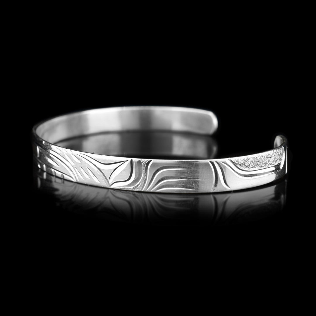 Right angle photo of the cuff bracelet depicts carvings representing the bear's other large paw.