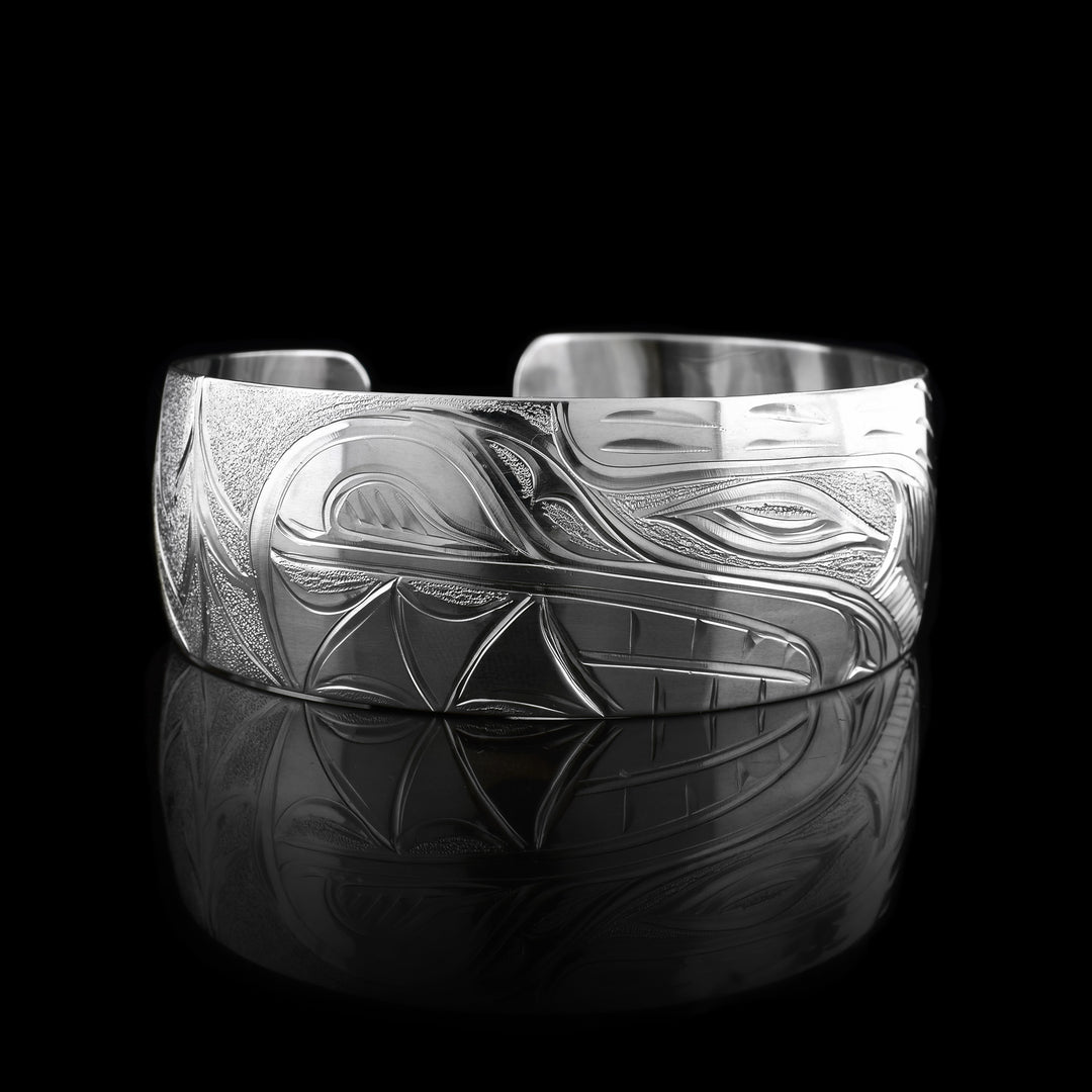 This sterling silver bracelet has a single, wide band with a gap in the back. The head of the Bear is depicted at a side profile. The Bear head is detailed with fine lines and etching.