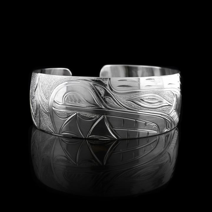 This sterling silver bracelet has a single, wide band with a gap in the back. The head of the Bear is depicted at a side profile. The Bear head is detailed with fine lines and etching.