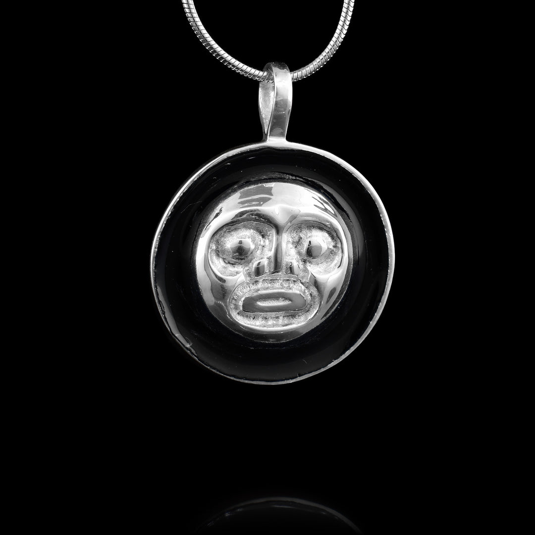 Black and Silver Moon Pendant, made with 99.9% silver surrounded by the black night sky.