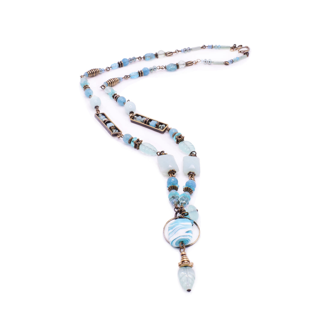 Honica statement necklace, a handcrafted piece from the "Solitude" collection. It features Amazonite, Aquamarine, Blue Quartz, Jasper, Kyanite, and Agate accented with Lampwork glass and Swarovski Crystals.