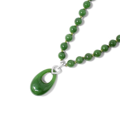 Beaded and knotted BC jade necklace with egg-shaped BC jade pendant. Egg-shaped cut out in pendant. Sterling silver bail has cubic zirconia.