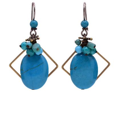 Blue dangle earrings made of handworked brass, turquoise, glass and magnesite. Titanium ear hooks. By Honica.