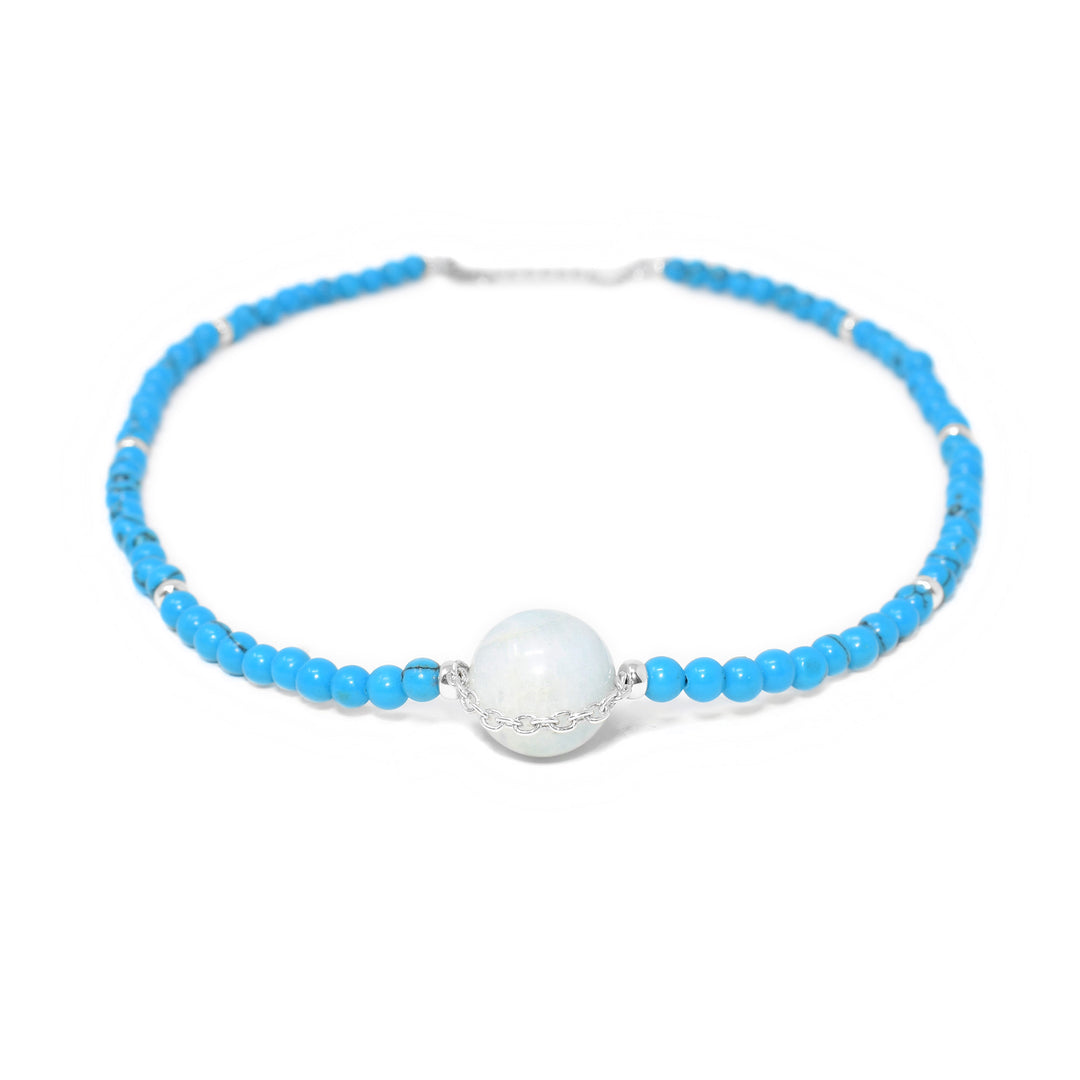 Sterling silver beaded necklace with round turquoise beads. Large, round, central aquamarine bead has small silver chain across front.
