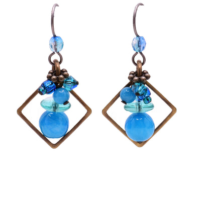 Dangle earrings made of Swarovski crystal, handworked brass, agate and glass. Titanium hooks. By Honica.