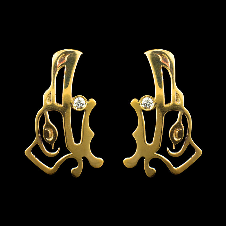 Elegant Raven drop earrings in polished brass with a diamond inlay. Hand-carved Raven face, Indigenous design meets modern luxury.