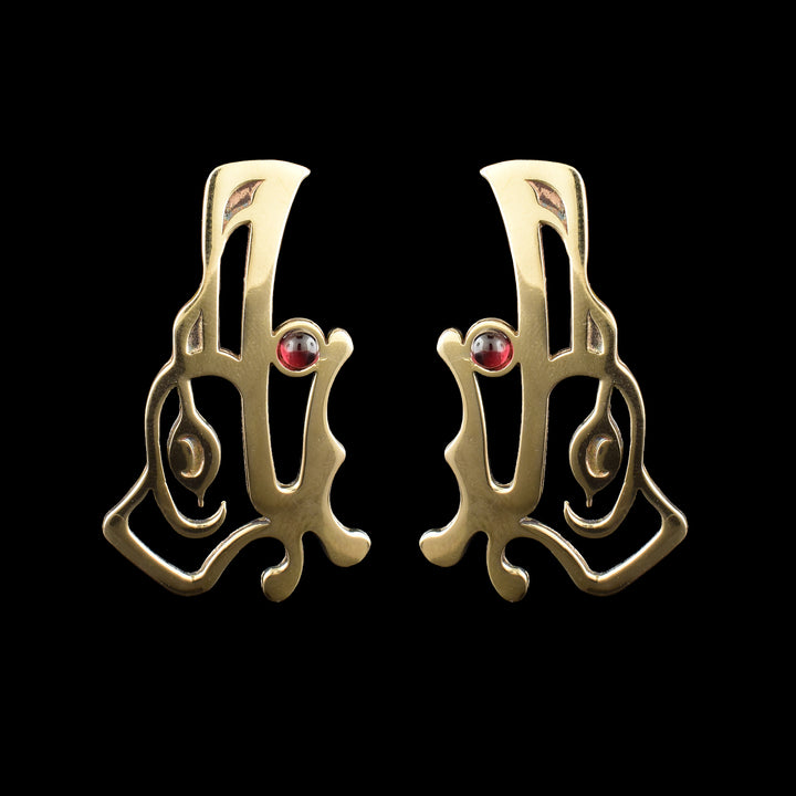 Handcrafted bronze Raven drop earrings by Haida Gwaii artist Gina Mae Schubert. Featuring a red garnet stone, in the mouth of the Raven.