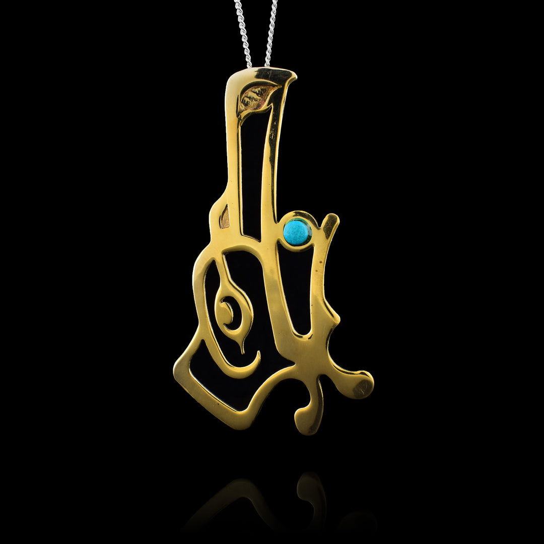 This bronze Raven pendant by Haida Gwaii artist Gina Mae Schubert. Handcrafted from bronze with a turquoise accent in the mouth, this large statement piece combines traditional design with durable materials.