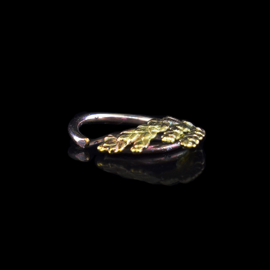 This Bronze and Gold Cedar Ear Cuff the leaf of cedar sits along a round cuff to pin to your ear. Makes for a perfect natural look.