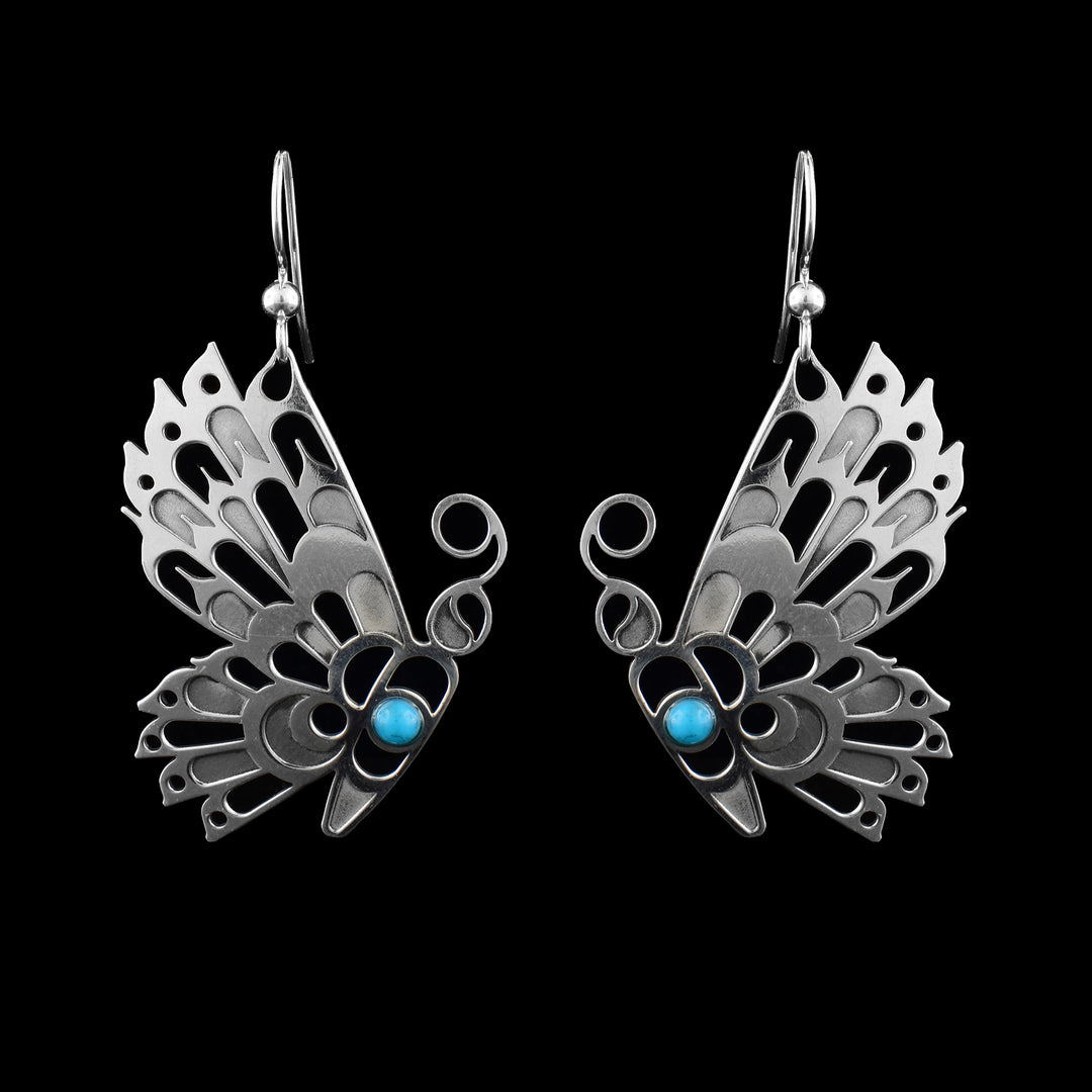 sterling silver Butterfly earrings by Haida Gwaii artist Gina Mae Schubert. Hand-carved dangles featuring a striking turquoise stone accent.