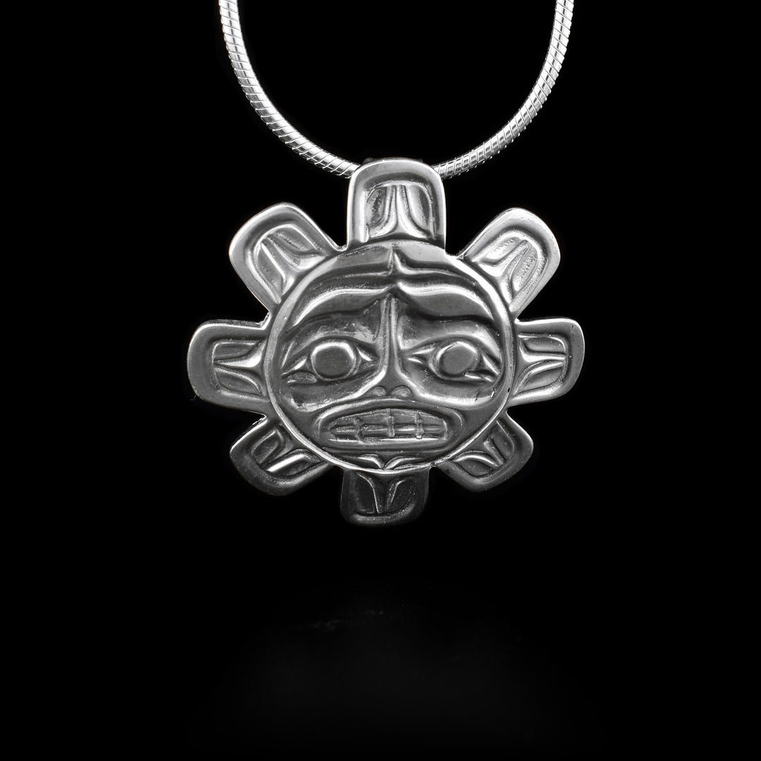 This sterling silver pendant is sun shaped and has carvings that depict the Sun carved into it.