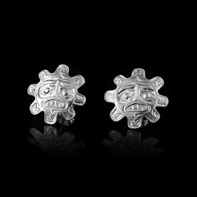 These Sun stud earrings are made from sterling silver and have Sun shaped studs. The studs are round and have rounded knobs extending out to imitate sun rays. The face of the Sun is detailed on the studs and shows eyebrow, eye, nose and mouth details.