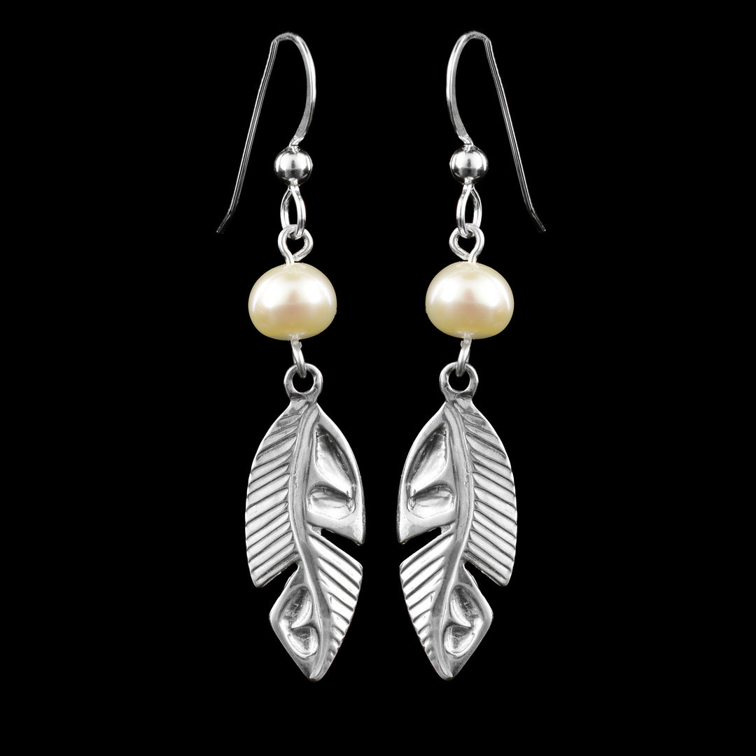 These sterling silver feather earrings have single, round freshwater pearls dangling from the hooks. Below the pearls are long, oval shaped feathers with feather lines cast into the surface of them.