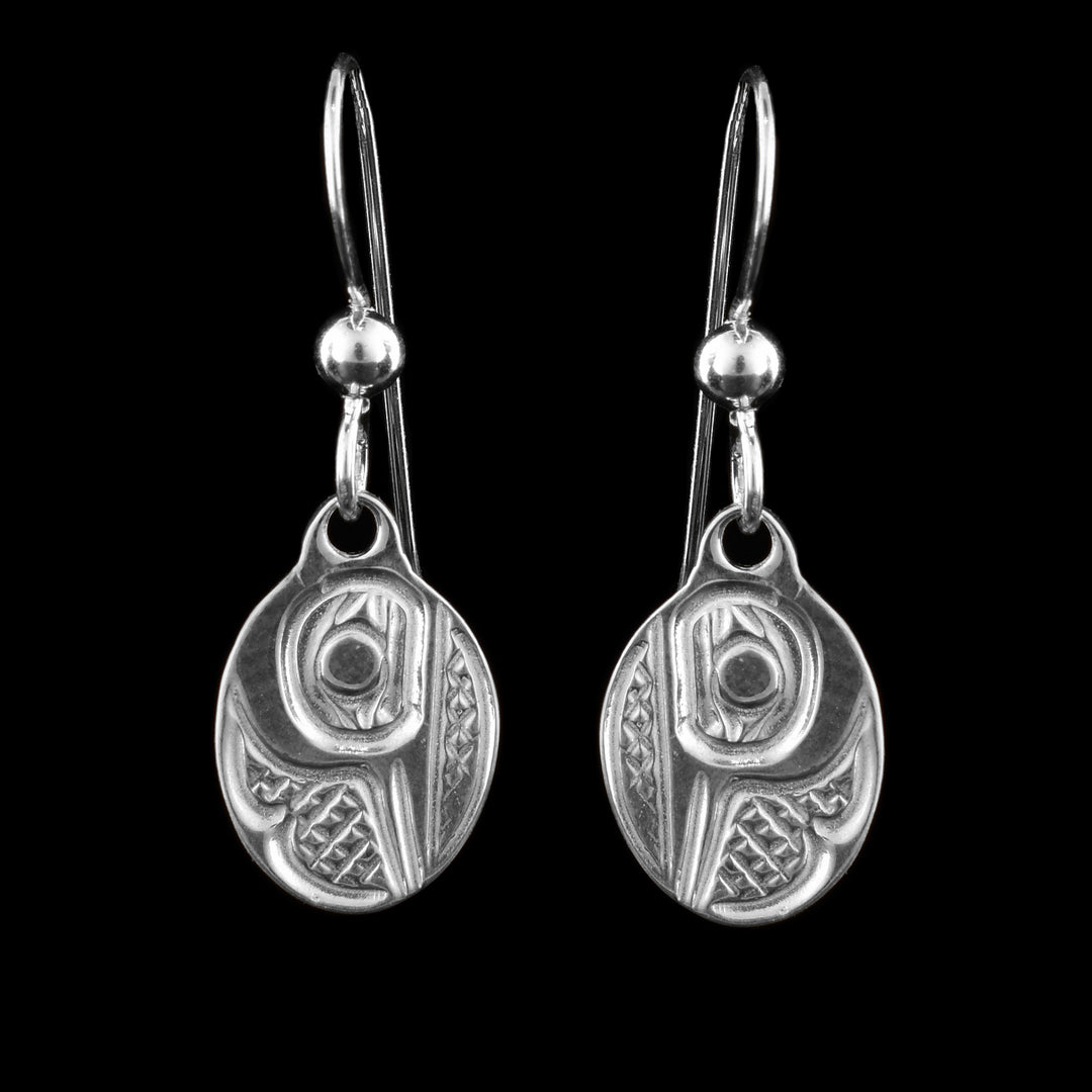 These sterling silver dangle Hummingbird earrings have small, oval hangs dangling from long hooks. The hangs depict the side profile of the head of the Hummingbird with cross hatching designs in the background. The beak of the Hummingbird is pointing down on the hangs.
