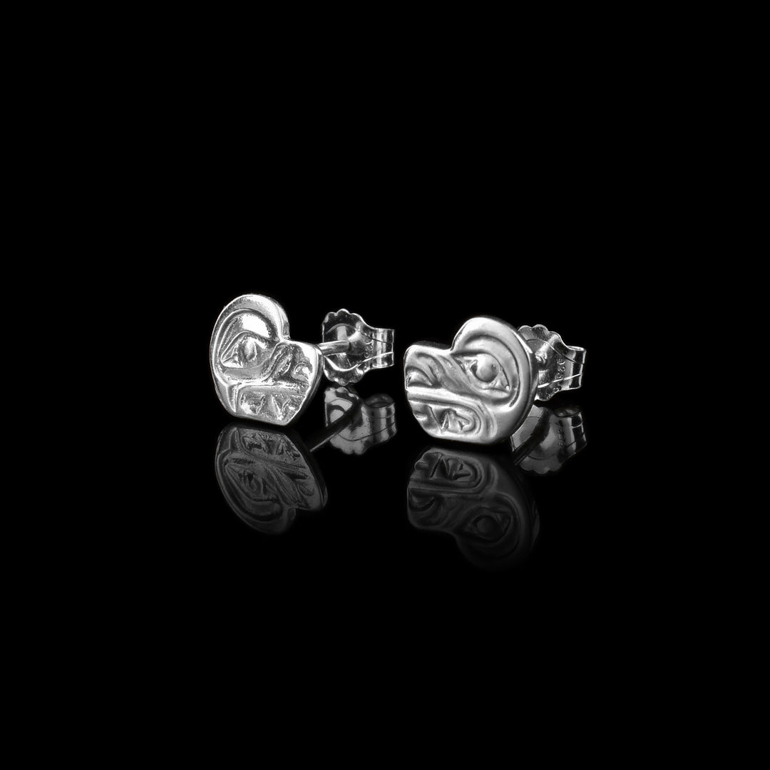 These sterling silver earrings small studs are shaped with a round head and a snout going out. There are nose, teeth, and eye details casted into the studs.