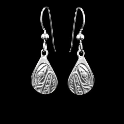 These dangling teardrop earrings have teardrop shaped hangs cast from sterling silver. The head of the Bear is cast into the hangs and its snout is facing down. The mouth is large and takes up most of the hangs. There are cross hatching designs in the background of the portrait.