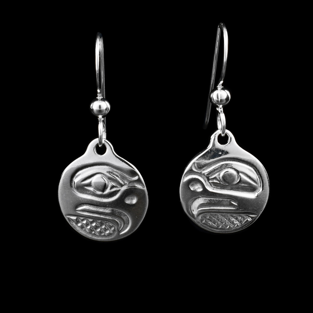 These sterling silver dangle earrings have small, circle hangs dangling from long hooks. The hangs depict the side profile of the head of the Eagle with cross hatching designs in the background.