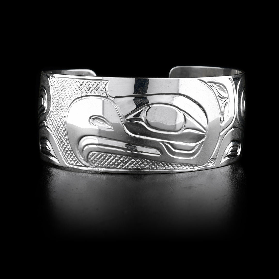 The wide, sterling silver cuff bracelet has a depiction of the Eagle carved into it.