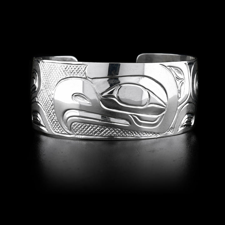 The wide, sterling silver cuff bracelet has a depiction of the Eagle carved into it.