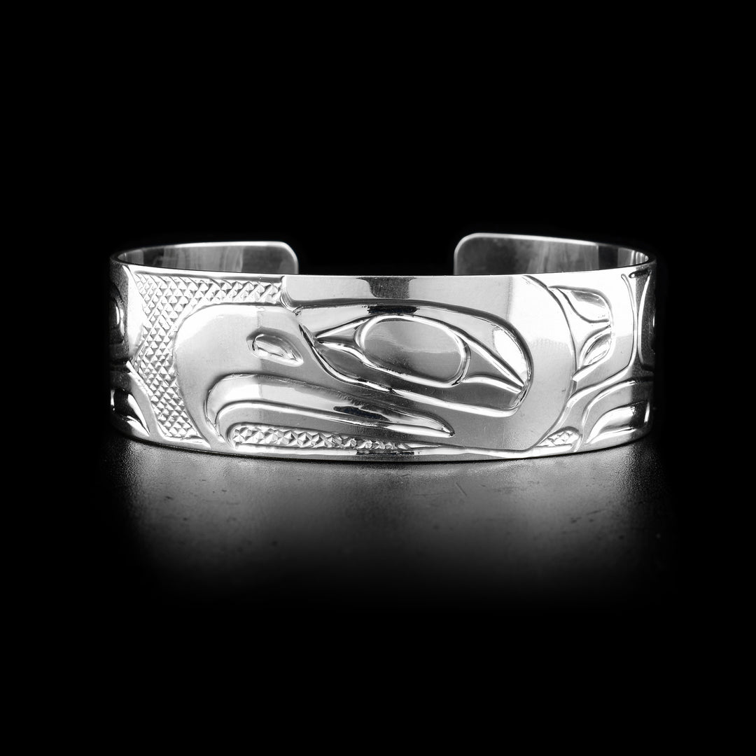 The wide, sterling silver bracelet cuff has a depiction of the Eagle carved into it.