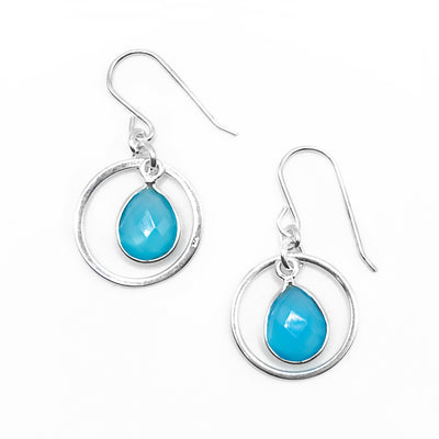 Dangle hoop earrings with flat, faceted blue chalcedony teardrops dangling in hoops. Metal is sterling silver.
