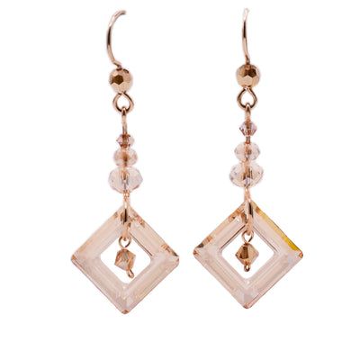 Dangle earrings made of Swarovski crystal, gold-filled beads, faceted glass and gold-filled wire. By Honica.