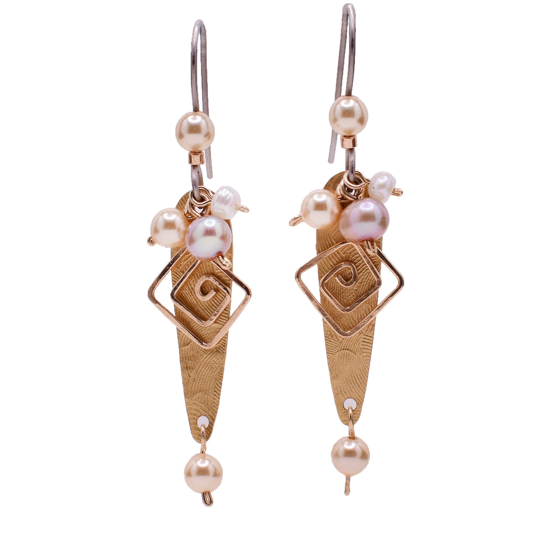 Dangle drop earrings made of handworked brass, goldfilled wire, crystal pearls, and freshwater pearls. Titanium ear hooks. By Honica.