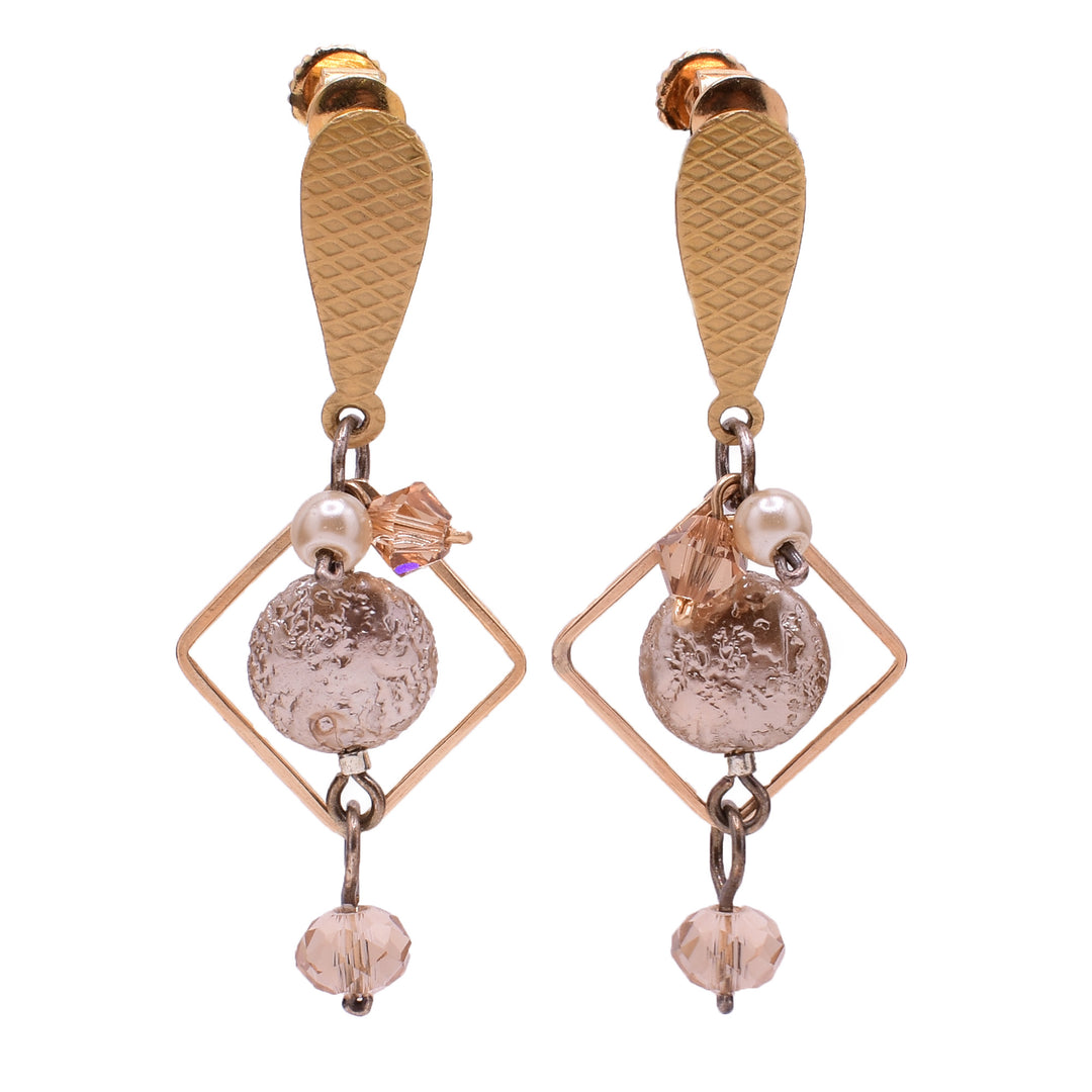 Dangle clip earrings made of Swarovski crystal, glass, silverfilled wire, and gold-filled wire. By Honica.