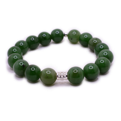 BC jade beaded bracelet with 0.4” jade beads, a small ornate sterling silver bead in front and a tiny round sterling silver bead in back.