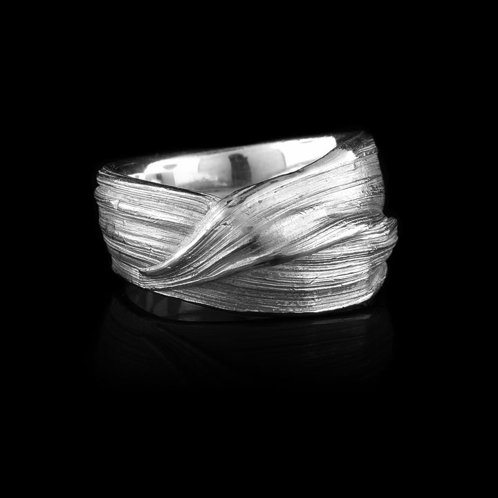 This sterling silver wavy ribbon chunky ring is hand-crafted by by Lisa-Marie Masse. The ring features hand-worked horizontal ridges, with lots of wavy texture.