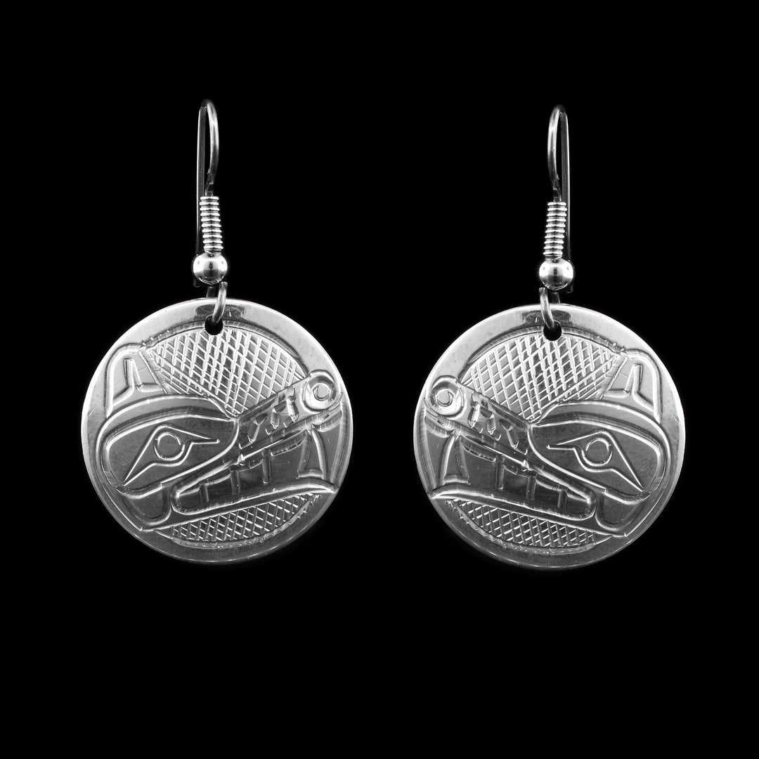 These sterling silver circular wolf earrings have been hand-carved with the legend of the wolf. They hang from french hooks