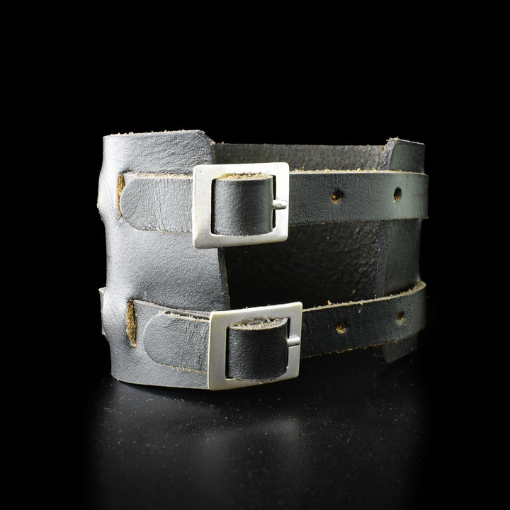Back of leather cuff with two straps and buckles for adjustment.