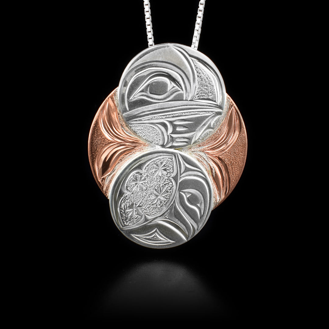 Sterling silver and copper hummingbird and moon eclipse pendant. Hidden bail on back. Hand-carved by Kwakwaka’wakw artist Cristiano Bruno.